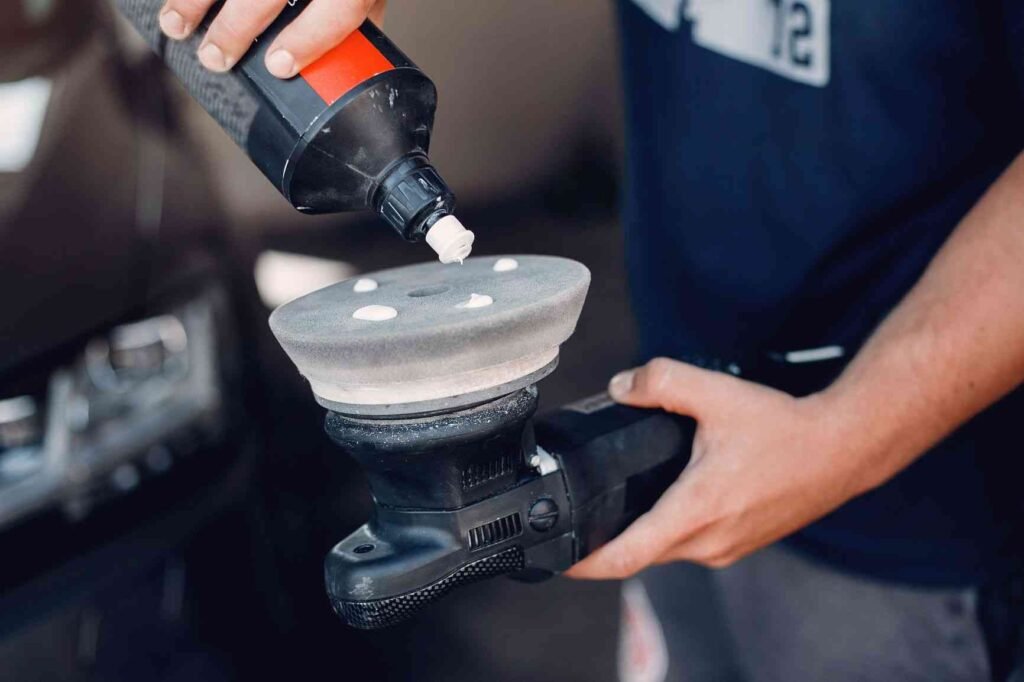 Close-up of a polished car surface reflecting light, highlighting the quality of the car polishing service.